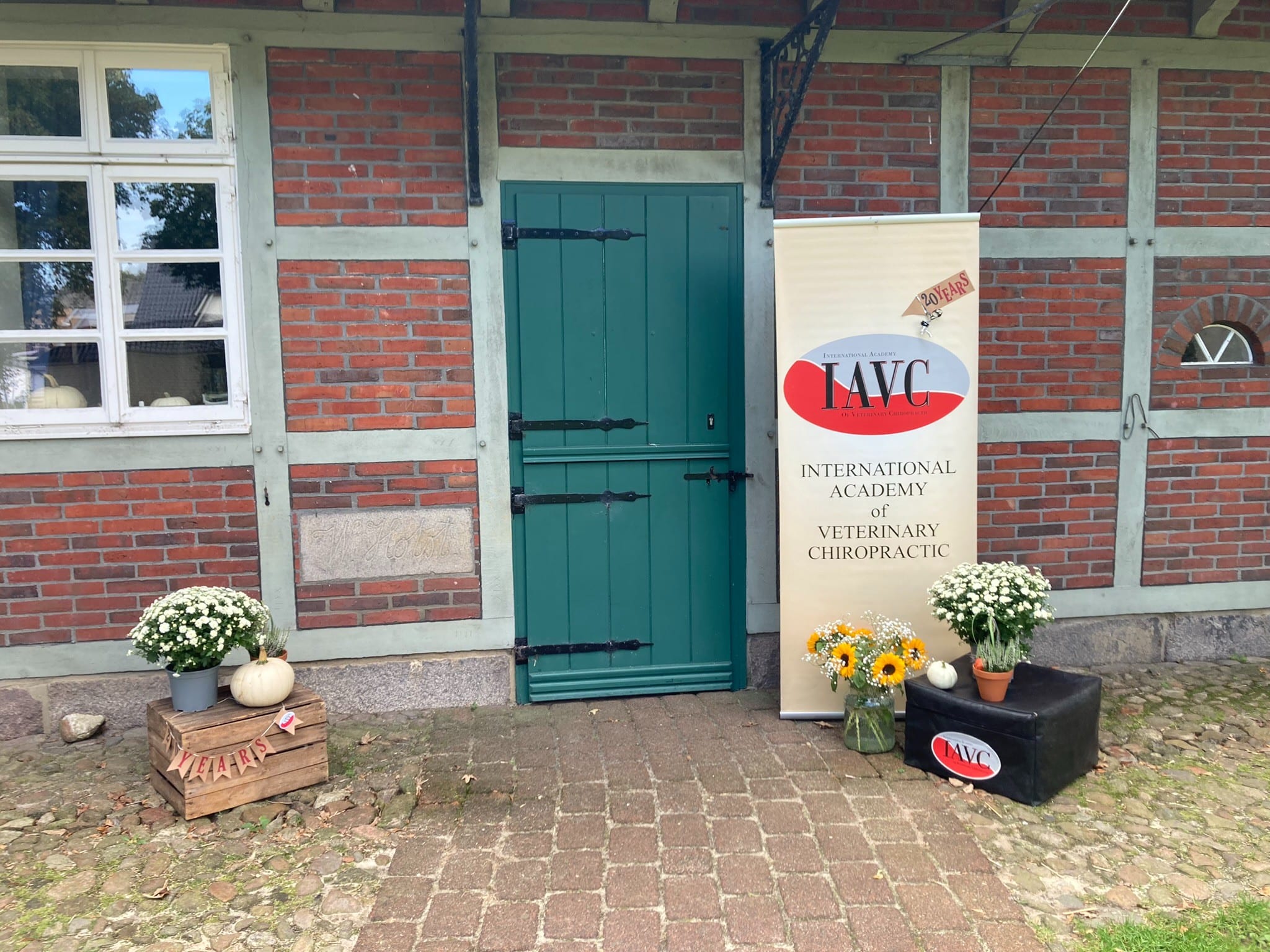 IAVC academy entrance with anniversary flowers and training display